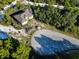 Aerial view of a house on a wooded lot with a driveway at 619 Alafia Pl, Poinciana, FL 34759