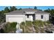 New construction home with block exterior and two-car garage at 619 Alafia Pl, Poinciana, FL 34759