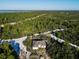 Aerial view of a home on a wooded lot with a large surrounding area at 619 Alafia Pl, Poinciana, FL 34759
