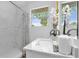 Updated bathroom with marble shower and vanity at 1603 Woodlyn Dr, Leesburg, FL 34748