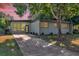 Mid-century modern home with landscaped yard at 1603 Woodlyn Dr, Leesburg, FL 34748