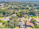Aerial view showcasing neighborhood homes and landscape at 1603 Woodlyn Dr, Leesburg, FL 34748