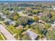 Aerial view showing a neighborhood with houses, trees, and roads at 1603 Woodlyn Dr, Leesburg, FL 34748