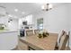 Light-filled dining area with wood table and chairs, adjacent to kitchen at 1603 Woodlyn Dr, Leesburg, FL 34748