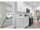Modern kitchen with white cabinets, quartz countertops, and stainless steel appliances at 1603 Woodlyn Dr, Leesburg, FL 34748