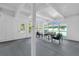 Spacious sunroom with large windows, concrete floors, and access to backyard at 1603 Woodlyn Dr, Leesburg, FL 34748