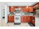 Updated kitchen with wood cabinets and a white stove at 1815 Larkin Ave, Orlando, FL 32812
