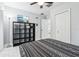 Bedroom with a queen bed, shelving unit, and closet at 1815 Larkin Ave, Orlando, FL 32812