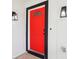 Eye-catching red front door with black trim and arched window at 1815 Larkin Ave, Orlando, FL 32812