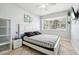 Spacious bedroom with a queen bed, built-in shelving, and window at 1815 Larkin Ave, Orlando, FL 32812