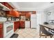 Modern kitchen offering wood cabinets, white appliances, and tiled floors at 1815 Larkin Ave, Orlando, FL 32812
