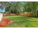 Spacious backyard with a grassy area and wooden fence at 1815 Larkin Ave, Orlando, FL 32812