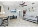 Open living space with a daybed, TV, and kitchen view at 1815 Larkin Ave, Orlando, FL 32812
