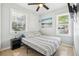 Cozy bedroom with a queen bed and two windows at 1815 Larkin Ave, Orlando, FL 32812