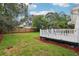 Large backyard with deck, grass, and mature trees at 1815 Larkin Ave, Orlando, FL 32812