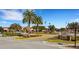 Community clubhouse with palm trees and ample parking at 500 Arena Dr, Davenport, FL 33837