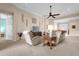 Living room with beige couches, ceiling fan and built-in entertainment center at 500 Arena Dr, Davenport, FL 33837