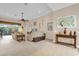 Living room with large TV, beige sofas, and decorative wall art at 500 Arena Dr, Davenport, FL 33837