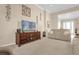 Living room with large TV, beige couches and entryway view at 500 Arena Dr, Davenport, FL 33837