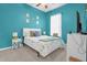 Bedroom with a queen bed, nightstands, and teal walls at 500 Arena Dr, Davenport, FL 33837