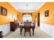 Formal dining room with wood furniture and orange walls at 500 Arena Dr, Davenport, FL 33837