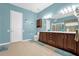 Bathroom with double vanity, large mirror, and shower at 500 Arena Dr, Davenport, FL 33837