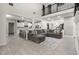 Open-concept living room with a large sectional sofa and high ceilings at 2393 Appy Ln, Apopka, FL 32712