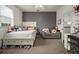 Charming bedroom with a full-size bed, gray accent wall, and a cozy sitting area at 2393 Appy Ln, Apopka, FL 32712