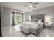 Main bedroom with king bed, marble floors, and pool view at 2393 Appy Ln, Apopka, FL 32712