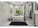 Bathroom with a freestanding tub and marble accents at 2393 Appy Ln, Apopka, FL 32712