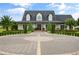 Beautiful two-story home with a circular driveway and well-manicured landscaping at 2393 Appy Ln, Apopka, FL 32712
