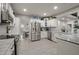 Elegant kitchen boasting white cabinets, granite countertops, and stainless steel appliances at 2393 Appy Ln, Apopka, FL 32712
