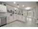 Spacious kitchen featuring white cabinets, granite countertops, and stainless steel appliances at 2393 Appy Ln, Apopka, FL 32712