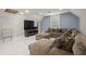 Game room featuring sectional sofa and large TV at 2393 Appy Ln, Apopka, FL 32712