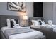 Modern bedroom with twin beds, sleek nightstands and artwork at 7514 Sunflower Cir, Kissimmee, FL 34747