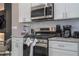 Modern kitchen with stainless steel appliances and granite countertops at 7514 Sunflower Cir, Kissimmee, FL 34747