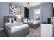 Spacious bedroom with two twin beds, nightstand, and large window at 7514 Sunflower Cir, Kissimmee, FL 34747