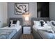 Well-lit bedroom with two twin beds and a nightstand at 7514 Sunflower Cir, Kissimmee, FL 34747