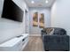 Cozy media room with a comfortable sofa and large TV at 7514 Sunflower Cir, Kissimmee, FL 34747