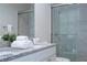Bright bathroom with double sinks and a glass shower at 7514 Sunflower Cir, Kissimmee, FL 34747