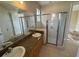 Double vanity bathroom with a large walk-in shower at 7706 Excitement Dr, Reunion, FL 34747