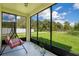 Screened porch with swing overlooking grassy backyard at 1033 Hacienda Cir, Kissimmee, FL 34741