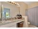 Bathroom with granite vanity, shower/tub combo, and linen closet at 1033 Hacienda Cir, Kissimmee, FL 34741