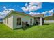 House exterior and grassy backyard with screened porch at 1033 Hacienda Cir, Kissimmee, FL 34741