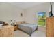 Cozy bedroom with wood furniture and a window with a view at 1033 Hacienda Cir, Kissimmee, FL 34741