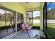 Relaxing screened porch with a swing and view of the backyard at 1033 Hacienda Cir, Kissimmee, FL 34741