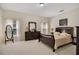 Bedroom with a dark wood bed frame, dresser, and carpeted floors at 1033 Hacienda Cir, Kissimmee, FL 34741