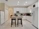 Bright kitchen with white cabinets, granite counters, and island at 1033 Hacienda Cir, Kissimmee, FL 34741