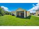 House with grassy backyard and screened porch at 1033 Hacienda Cir, Kissimmee, FL 34741