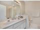 Double vanity bathroom with granite countertop and shower at 1033 Hacienda Cir, Kissimmee, FL 34741